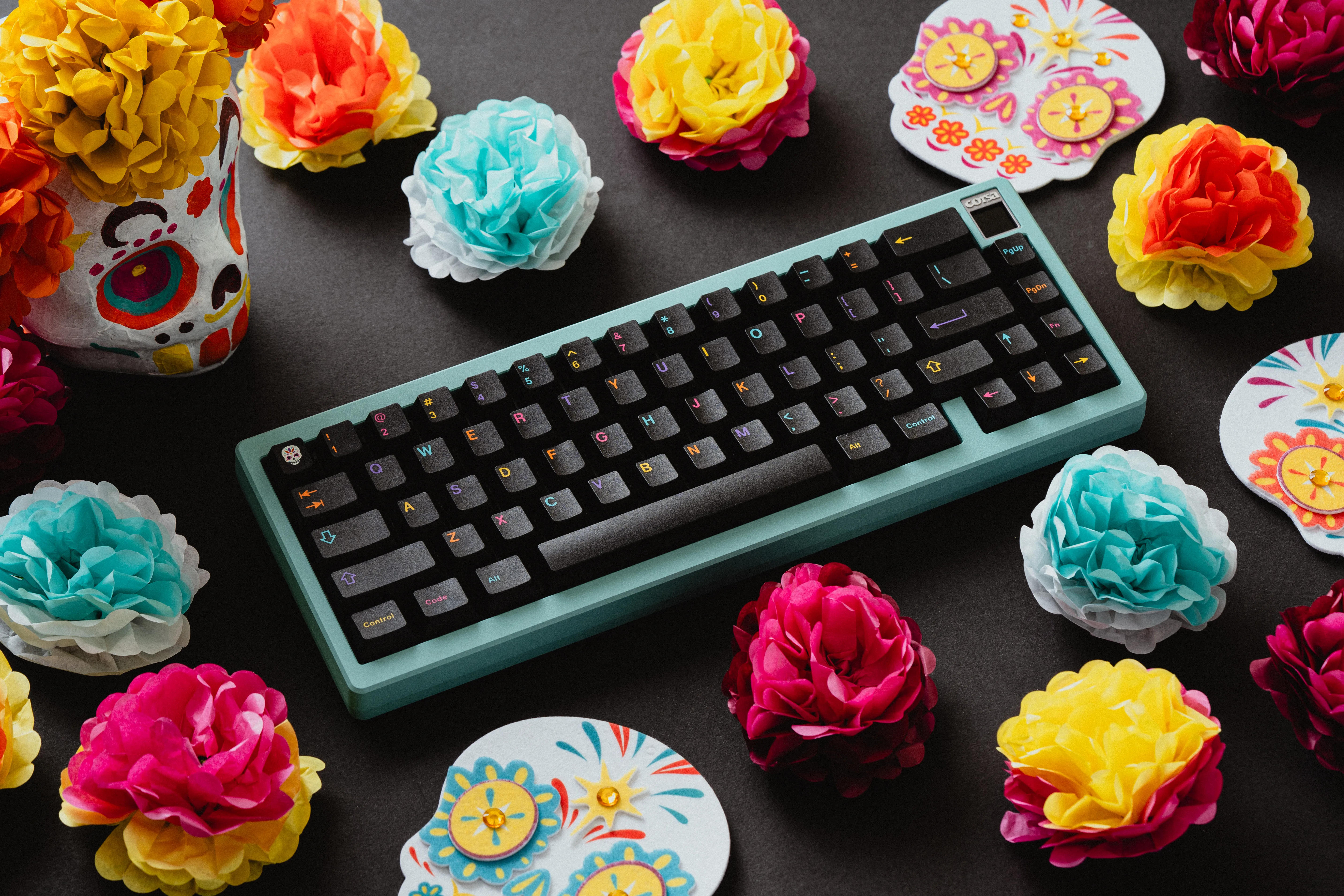 GMK Mictlán keyboard surrounded by paper flowers and Day of the Dead decorations